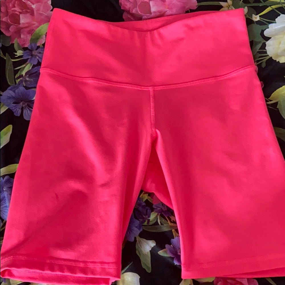 Neon pink biker shorts.